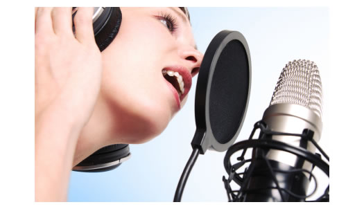 http://blogs.voices.com/voxdaily/woman-recording-microphone-ear-phones.jpg